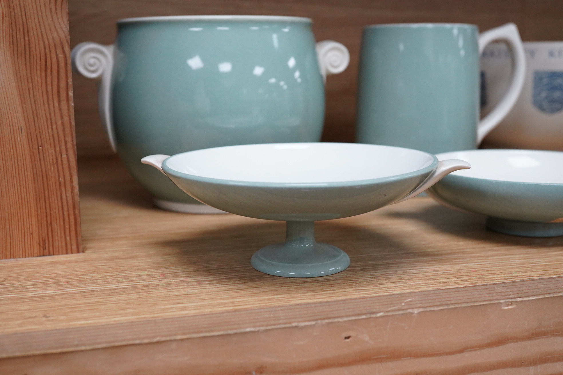Keith Murray for Wedgwood - a celadon mug, two handled vase and two tazzas, tallest 13cm